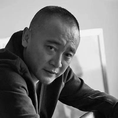 a picture of hong shao li looking into the camera from an angle